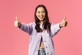 Totally agree. Portrait of cheerful young woman in denim jacket approve awesome, super cool idea, show thumbs-up and