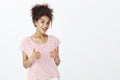 Totally agree with your opinion. Satisfied happy and outgoing woman with dark skin in striped t-shirt, raising thumbs up