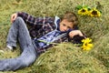 Totally carefree. Small boy relax in hayloft. Small boy in farm barn. Hayloft in countryside. Just relaxing