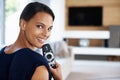 Totally in control. a happy young woman with a remote control looking back at the camera. Royalty Free Stock Photo