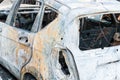 Totally destroyed cars burned in fire in the war zone or in civil demonstrations close up Royalty Free Stock Photo