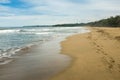 A totally empty sandy beach just south of Puerto Viejo de Talamanca in Costa Rica, footprints leading off into the Royalty Free Stock Photo