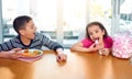 This is totally unfair. an unhappy young boy screaming because he has to eat vegetables while his sister has Royalty Free Stock Photo