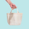 Tote bag canvas white cotton fabric cloth for eco shoulder shopping sack mockup blank template isolated on blue background Royalty Free Stock Photo