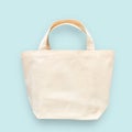 Tote bag canvas white cotton fabric cloth for eco shoulder shopping sack mockup blank template isolated on pastel blue background Royalty Free Stock Photo