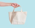 Tote bag canvas white cotton fabric cloth for eco shoulder shopping sack mockup blank template isolated on pastel blue background Royalty Free Stock Photo