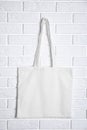 Tote bag hanging on brick wall. Mock up