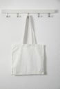 Tote bag hanging on white wall