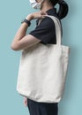 Tote bag mockup with canvas white cotton fabric cloth for eco shopping handbag mock up blank template on shoulder of girl