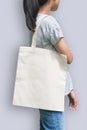 Tote bag mockup on girl shoulder clipping path in white cream color