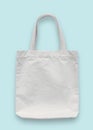 Tote bag mockup, white blank cotton fabric canvas cloth for eco shoulder shopping sack mock up template isolated on pastel blue Royalty Free Stock Photo