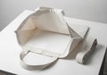 Tote bag and a neatly folded strap, both in a natural off-white Royalty Free Stock Photo