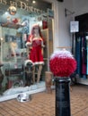 TOTNES, DEVON, UK - December 06 2019: Festive hand knitted bollard decoration outside the Animals In Distress charity shop Royalty Free Stock Photo