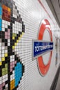 Tottenham Court Road Underground Station, London, UK showing mosaic tiles by Eduardo Paolozzi and the TFL Roundel in soft focus. Royalty Free Stock Photo