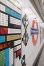 Tottenham Court Road Underground Station, London, UK showing mosaic tiles by Eduardo Paolozzi and the TFL Roundel in soft focus. Royalty Free Stock Photo