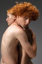 Portrait of beautiful redhead couple isolated on grey studio background. Concept of beauty, skin care, fashion and style Royalty Free Stock Photo