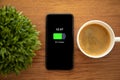 Touch phone with charged battery on the screen Royalty Free Stock Photo