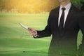 Touch screen in hand the businessman on golf course. Meeting conferenc.