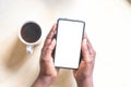 Touch screen mobile phone, in African woman`s hand. Black Female holding smart phone on green outdoor background with blank copy s Royalty Free Stock Photo