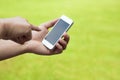 Touch screen mobile phone in hand with green meadow Royalty Free Stock Photo