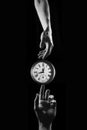 Touch of time - hands touching a clock with numbers Royalty Free Stock Photo