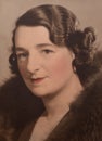 Touched up colour photograph of elegant Caucasian woman with wavy hair and wearing fur, dating to the 1920s.