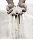 Touching the beach. Shot of a man with a handful of sand falling through his fingers.