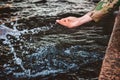 The Girl`s hand splashes water and drops fly.