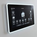 A touchscreen control panel for a smart home system is affixed to a wall. The