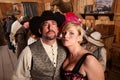 Tough Cowboy and Showgirl in Saloon Royalty Free Stock Photo