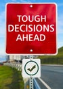 Tough Decisions Ahead road sign.