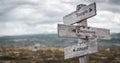 Tough decisions ahead text engraved on wooden signpost outdoors in nature. Royalty Free Stock Photo