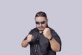 A tough looking bodyguard or security escort challenges someone to a fistfight. A man wearing shades ready to defend himself in Royalty Free Stock Photo