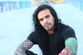 Tough looking hispanic man with long hair and tattoos Royalty Free Stock Photo