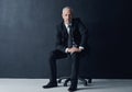 Tough minded and determined to succeed. Studio portrait of a mature businessman against a dark background.