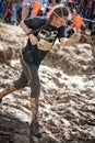 Tough Mudder: Young Female Racer Running through the Electric Obsticle