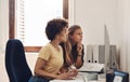 This is a tough one...two businesswomen working together on a computer in an office. Royalty Free Stock Photo