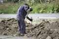 Tough worker with iron chain and sledgehammer