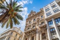 Toulon, France. Low angle view of historical buildings and palm tree against blue cloudy sky. Royalty Free Stock Photo