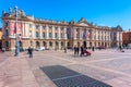 TOULOUSE, FRANCE - MARCH 26, 2017 : Tourists walking in the Capitole de Toulouse, Facade of the Capitol, the City Hall of Toulouse Royalty Free Stock Photo