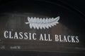 Classic all blacks sign text and logo brand front of new zealand rugby fashion store