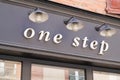 One step brand sign and text logo front of store fashion trend girls women boutique