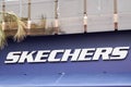 Skechers logo brand and text sign front of athletic footwear shop brand shoes store