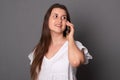 Toung woman emotionally talking on a mobile phone. Happy young woman