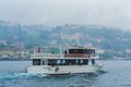 Tour boat on Bosphorus strait on rainy spring day Istanbul city Turkey Royalty Free Stock Photo