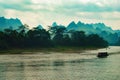 Tour boat on Chinese river with stunning mountains