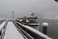 Tour boat on Konigssee lake at blizzard in winter time. Berchtesgaden, Bavaria, Germany.