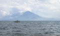 Tour boat on lake Atitlan with view to the volcano at Panajachel, Guatemala