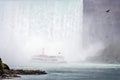 Tour boat in the mist under Horseshoe Falls on the Niagara River Royalty Free Stock Photo