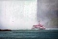 Tour boat in the mist under Horseshoe Falls on the Niagara River Royalty Free Stock Photo